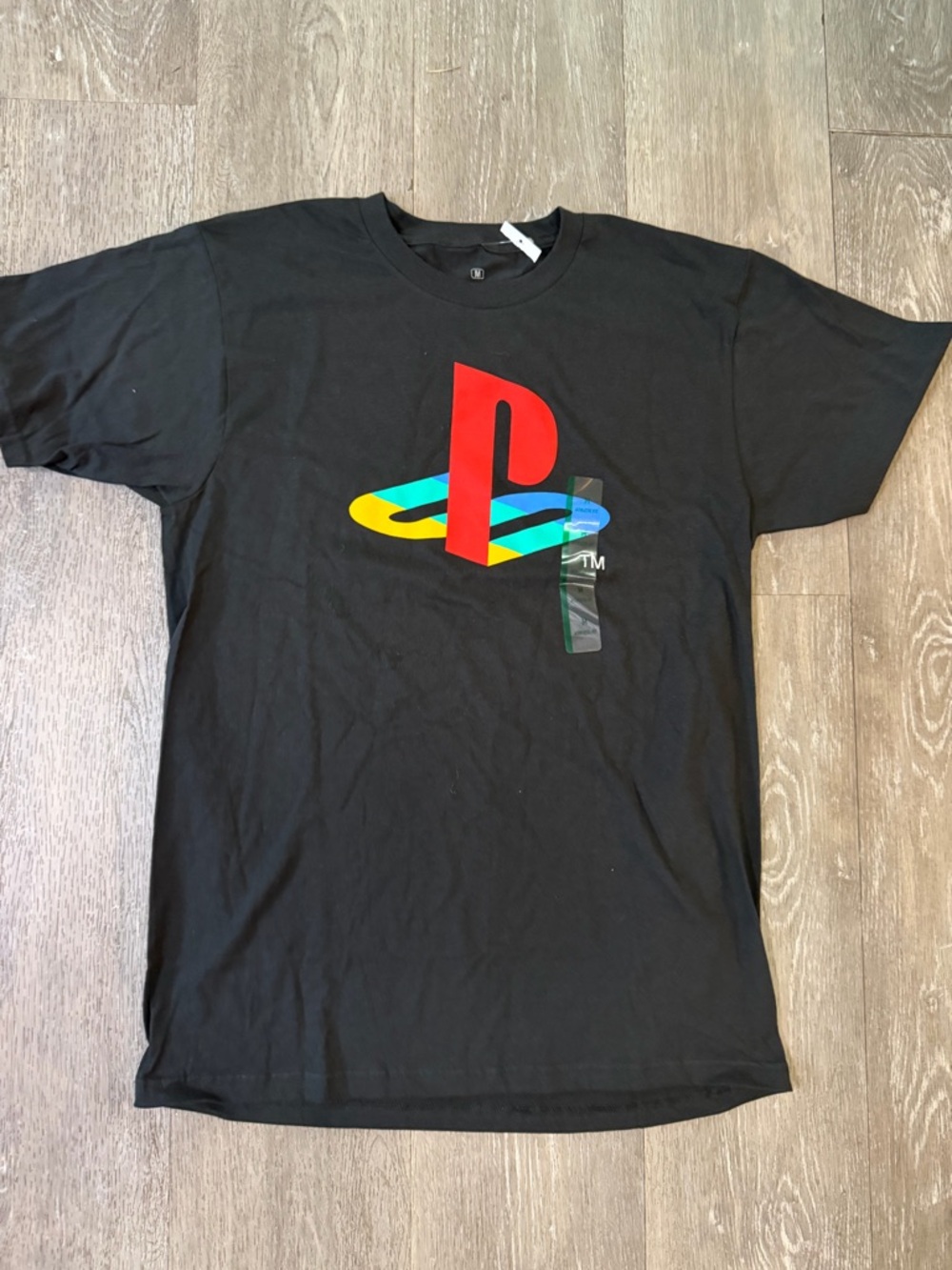 Black Tee with Multicolor Emblem and TM Mark